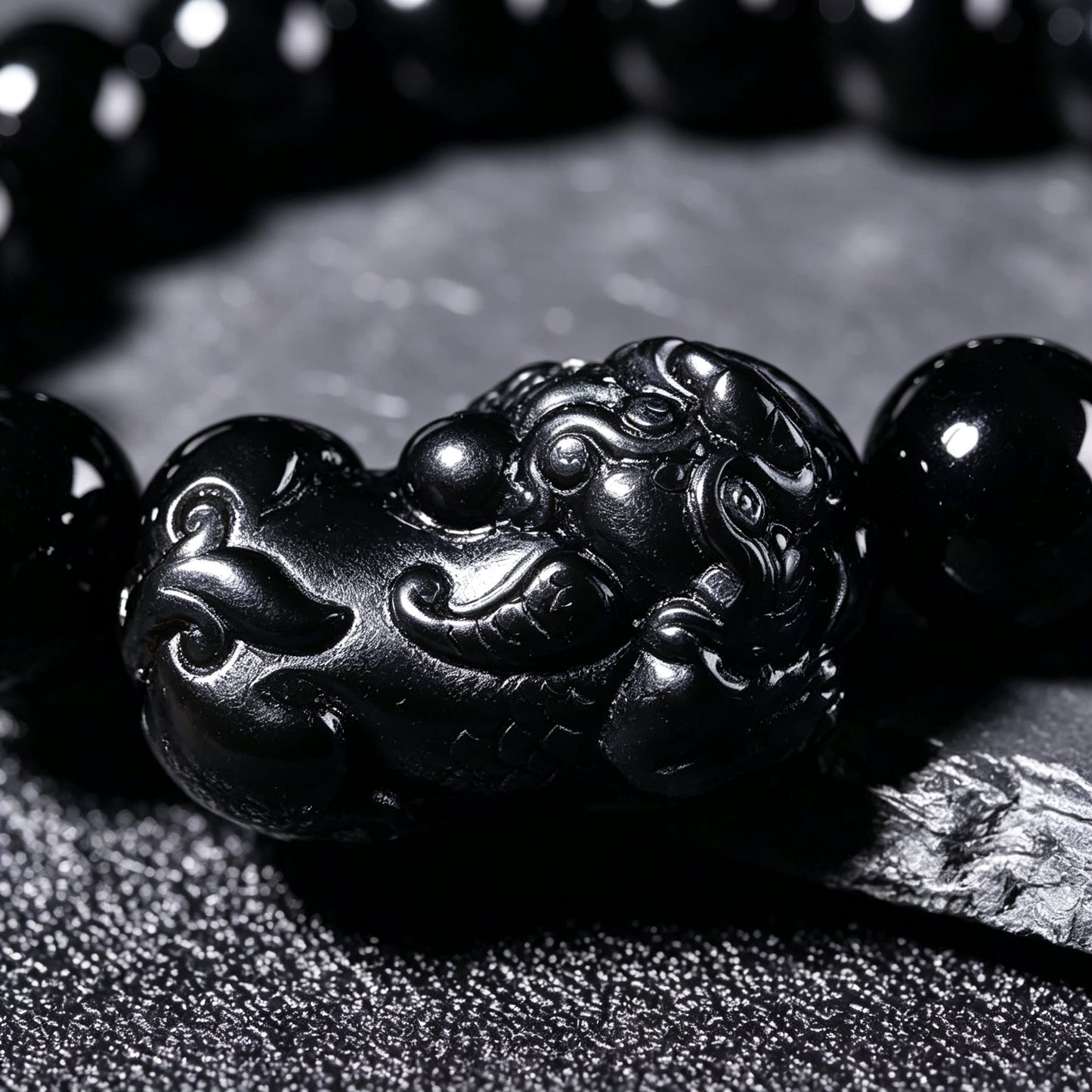 Black obsidian bracelet worn on a man's wrist – WUFORGE